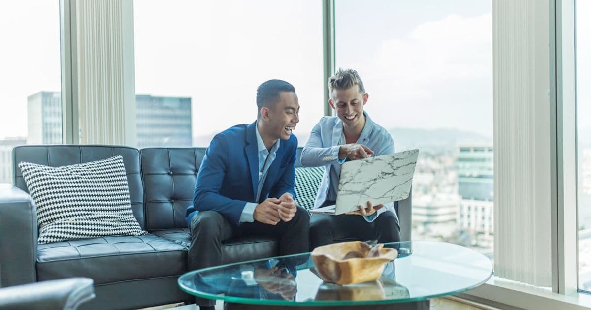 Solicitor and client reviewing property sale exchange of contracts at a desk
