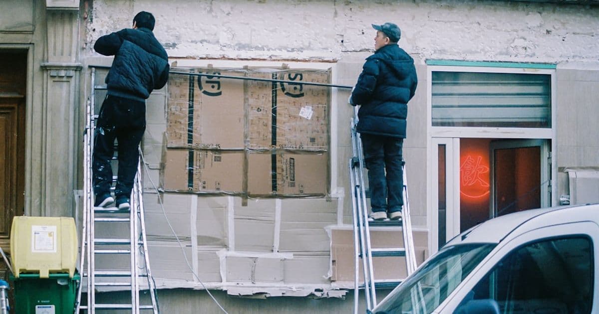 Construction workers installing insulation during a commercial building energy retrofit