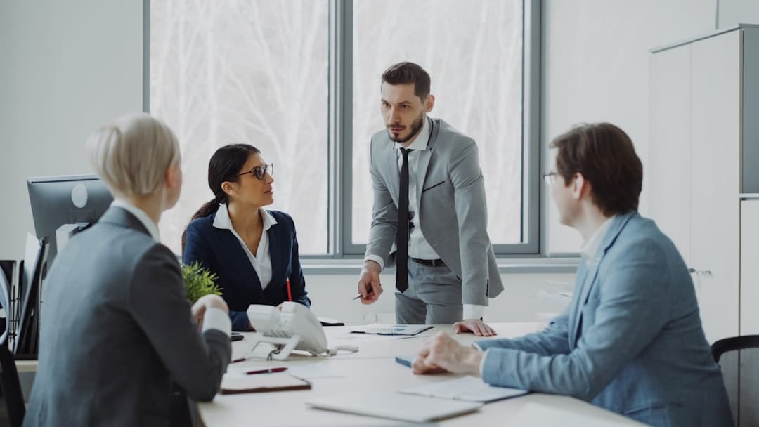 Professionals reviewing documents in a boardroom, representing commercial real estate due diligence